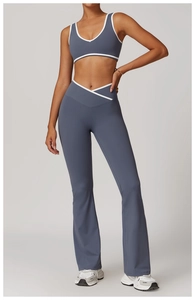 Detail of high-waisted yoga set in dusty blue with white contrast trim and V-neck top