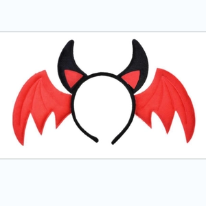 Detailed view of red bat wings and black horns headband for Halloween costume