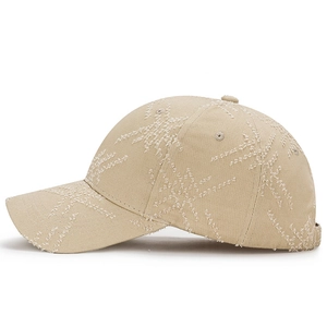 Beige distressed cotton baseball cap with star-shaped patterns and curved brim