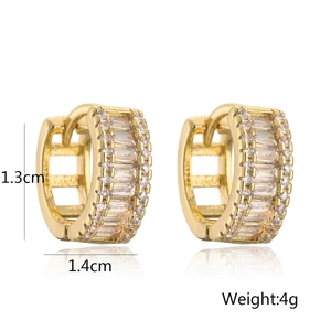 Macro detail of gold-plated huggie earrings with cubic zirconia and size specifications