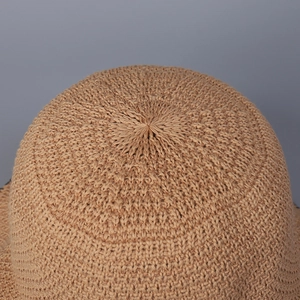 Macro detail of khaki knitted sun hat crown showing fine woven texture and craftsmanship