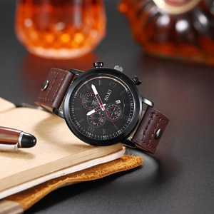 Men's business quartz watch with black dial and brown leather strap on leather notebook