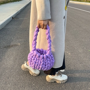 Close-up of hand-knitted purple chunky yarn tote bag with soft braided handle
