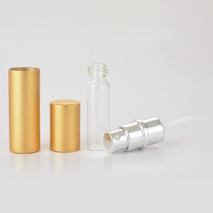 Detailed view of disassembled 5ml gold perfume atomizer with glass vial and spray pump