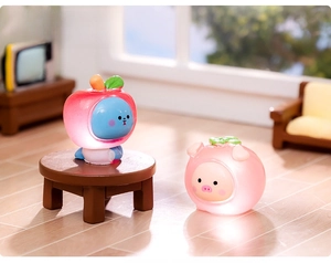 Detailed close-up of luminous miniature resin figurines featuring bear and pig fruit styles
