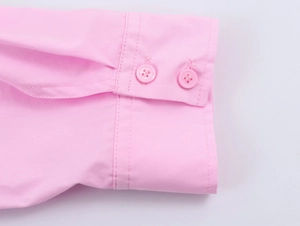 Detail of pink cotton shirt cuff featuring double-button closure and fine stitching