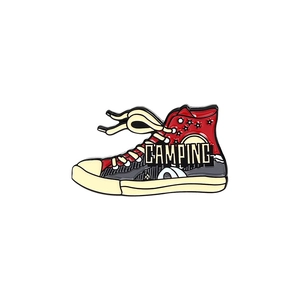Detail of high-top canvas shoe enamel pin with camping theme and star silhouette