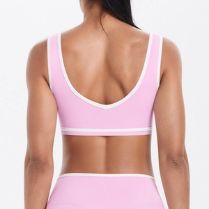 Rear view of pink sports bra with U-back design and white contrast piping detail