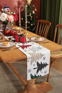 Detail of Christmas table runner featuring red plaid and leopard print trees on beige fabric