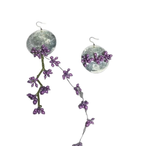 Elegant asymmetrical shell flower tassel earrings with purple berry beads and long dangles