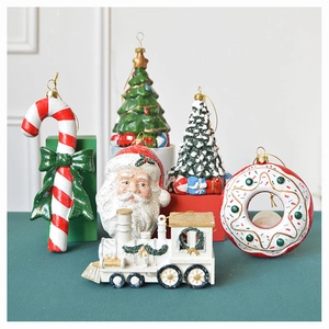 Detail of Christmas tree ornaments including Santa, candy cane, and donut with gold strings
