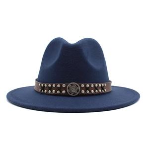 Close-up of navy wool fedora with brown leather band, rivets and vintage gear emblem