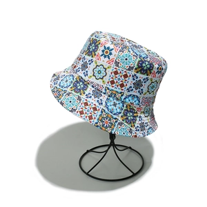 Detail of colorful bohemian bucket hat with mosaic patterns on a display stand