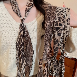 Close-up of leopard print chiffon scarf necklace with metallic rings and black beads