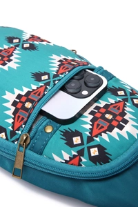 Detail of bohemian geometric crossbody bag showing spacious interior with a smartphone