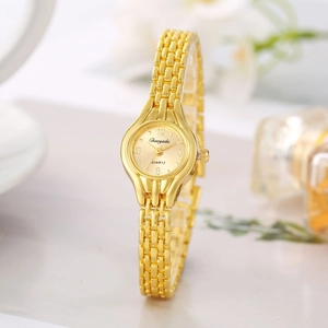 Detail of elegant gold chain watch with quartz movement next to perfume bottle