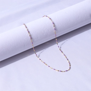 Detail of 18k gold plated stainless steel chain necklace with purple enamel beads