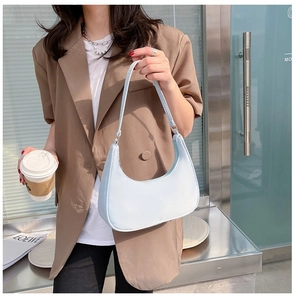 Close-up of light blue nylon hobo bag on a model's shoulder for casual daily use