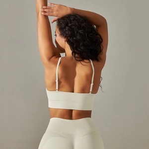Detail of seamless ribbed beige yoga bra with adjustable straps and open back design