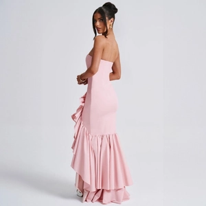 Detail of light pink off-shoulder fishtail dress with layered ruffle hem and slim fit