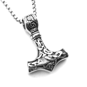 Detailed view of silver Mjolnir pendant with Celtic knots and animal engravings