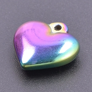 Macro view of a 3D heart pendant with a vibrant iridescent rainbow finish on steel