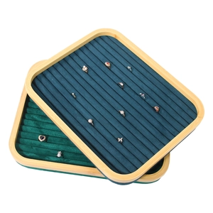 Bamboo jewelry organizer tray with blue and green velvet slots for rings and earrings