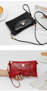 Detailed view of glossy crocodile pattern bags in black and red with elegant hardware.