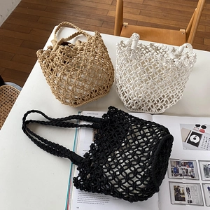 Bohemian woven cotton rope bucket bags in white, khaki and black colors on table