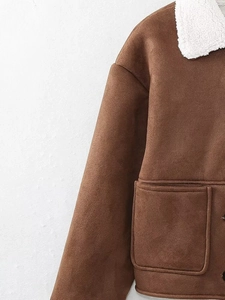 Detail of caramel brown cropped jacket featuring large pockets and white sherpa collar