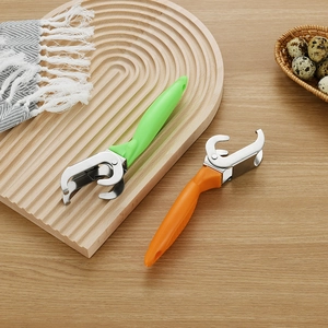 Macro shot of green and orange stainless steel bowl clips on a rustic wooden table