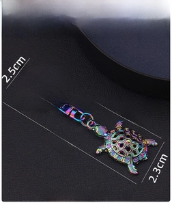 Macro shot of colorful iridescent sea turtle keychain with star-shaped ring and alloy shell