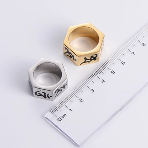 Hexagonal stainless steel Sanskrit rings in gold and silver showing 1cm width scale