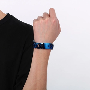 Close-up of a 20mm blue stainless steel Cuban link bracelet worn on a male wrist