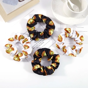 Set of 4 satin softball print scrunchies in black and white with shiny silk texture