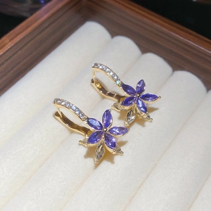 Detail of flower earrings with purple marquise stones and gold diamond-set hooks