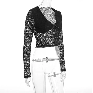 Detail of black lace long sleeve top with deep V-neck and delicate front ribbon tie