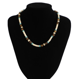 Detail of bohemian men's necklace with white, turquoise and brown wooden beads on mannequin