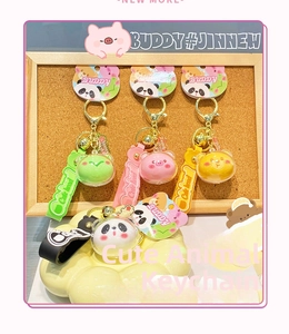 Detail of cute panda, pig, bear and frog acrylic keychains with silicone straps and bells