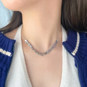 S925 sterling silver necklace featuring an A-Z letter heart pendant cluster on a model