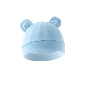 Detail of light blue baby beanie with cute bear ears and soft knitted texture on white background