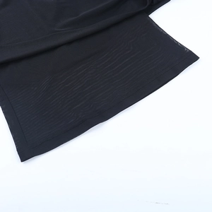 Detail of sheer black mesh fabric and stitching on off-shoulder long-sleeve T-shirt