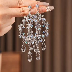 Detailed close-up of hollow water drop fringe earrings with colorful sparkling rhinestones