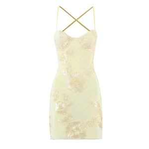 Pale yellow slim fit dress with floral embroidery and crisscross back straps on white background