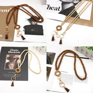 Macro detail of Nordic style wooden bead lanyards with leather tassels and gold clasps