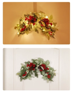 Detail of Christmas swag with red berries, pine cones and warm LED lights
