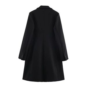 Detail view of the back seams and buttoned cuffs on a long black wool blend coat