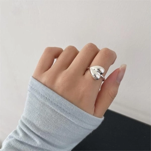 Close-up of a 925 sterling silver heart-shaped open ring worn on a finger