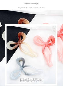 Detailed view of bow-shaped hair claws with gradient colors and matte texture