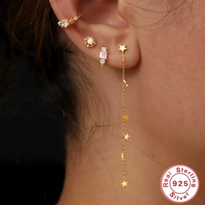 Golden S925 sterling silver earring set with tassel star and zircon on ear model